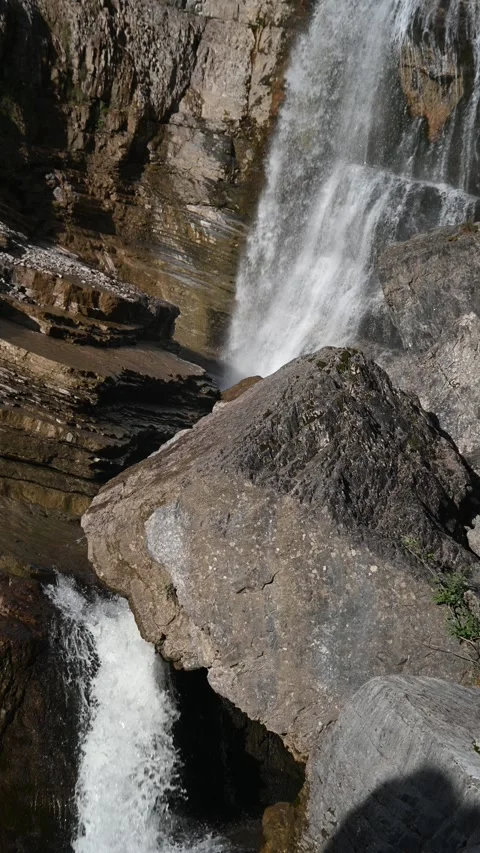 A huge rock in front of a waterfall, vertical shot Video stock 260871136