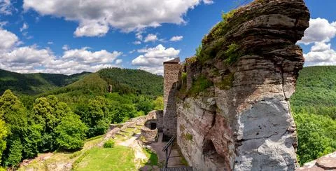 Huge rock with a ruined castle near the French village Lembach Stock Photos
