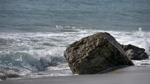 A huge rock on the sandy shore of the beach Stock Footage 133488582