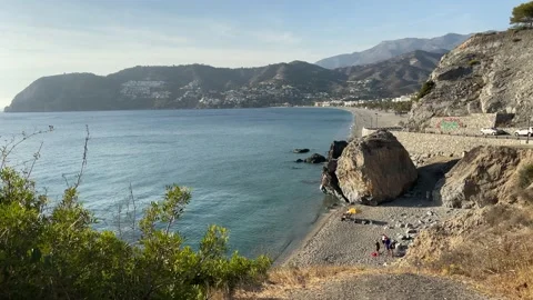 A huge rock separates a small beach from the main beach. Stock Footage 187215292
