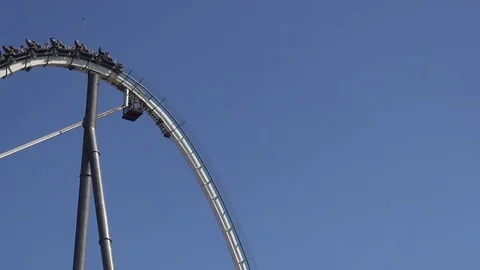 Huge roller coaster ride dive on an amusement park with amazing blue sky Vídeos de archivo 69734145