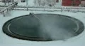 Huge round tanks for waste water treatment with steam over in factory HD Footage