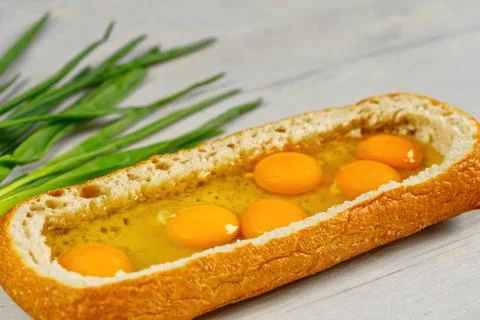 Huge sandwich with raw eggs inside. Stuffed big ciabatta bread with raw Stock Photos