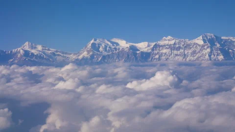 Huge sea of cloud beneath a mountain range in the distance shining. Stock Footage 281222501