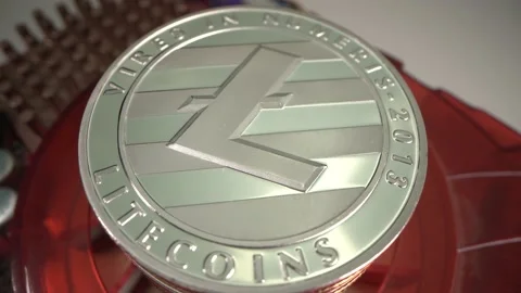 Huge silver Cryptocurrency Lite coin rotate on red graphic card with white Stock Footage 132321870