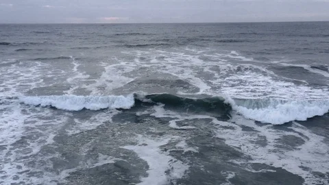 Huge slow-motion wave crashes as camera pulls backwards Stock Footage 112703926