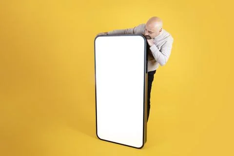 Huge smartphone empty screen for mock up, Middle aged man looking screen. Stock Photos