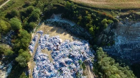Huge smelling dump polutes air close to agricultural corn field. Video stock 80987642