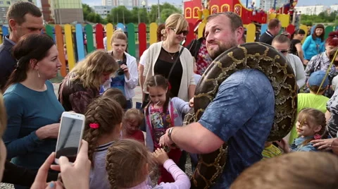 Huge snake Python around the shoulders of man Stock Footage 63789673