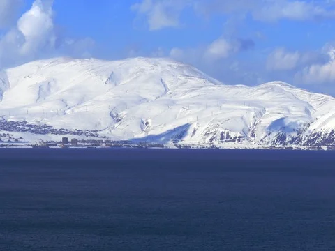 Huge Snow Covered Mountains Next to Lake Stock Footage 73549635