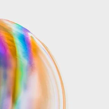 Huge soap bubble with colourful pattern against white background 스톡 사진
