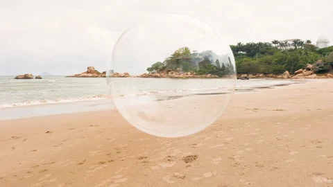 Huge soap bubble flying along seacoast. Stock Footage 262436705