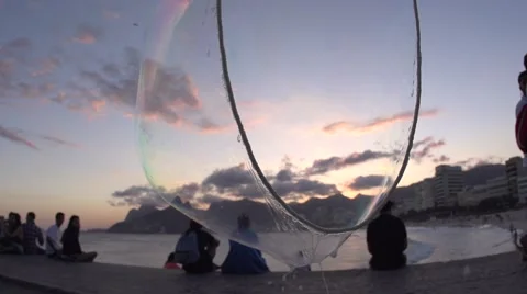 Huge soap bubble at Rio de Janeiro sunset in slowmotion Stock Footage 68103200