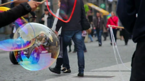 Huge soap bubbles blown on city street, children people walking Stock Footage 43682122