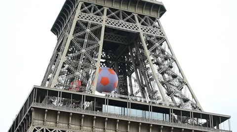 Huge soccer ball suspended on the Eiffel Tower during EURO 2016 스톡 동영상 64671833