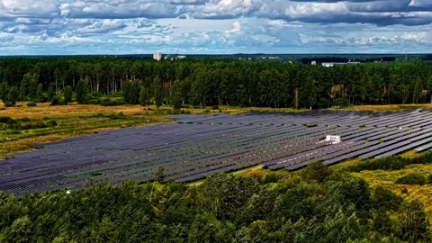 Huge Solar Farm Surrounded by Dense Forest in Rural Latvia Aerial View Video stock 334125500