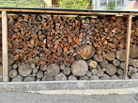 Huge stack of cut logs and lumber from trees, taken in Zermatt, Switzerland Stock Photos