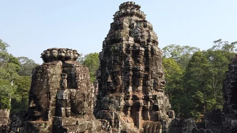 Huge stone faces on the towers of the ancient temple. Bayon. Angkor. Cambodia Stock Footage 107282134