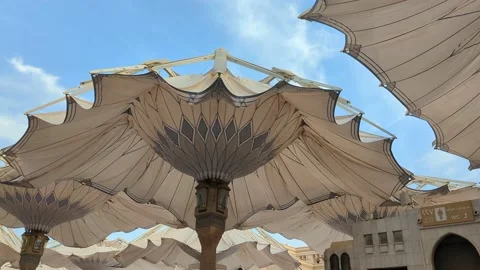 A huge stone pillars with umbrellas in mecca Saudi Arabia under the sun Stock Footage 194764796