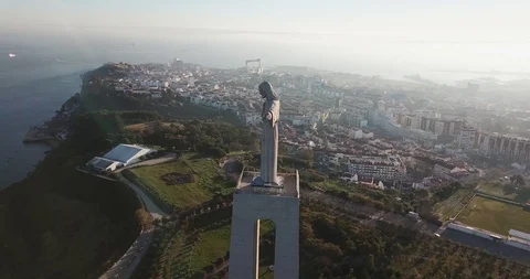 A huge stone statue monument over the city by the sea at dawn Stock Footage 130116249