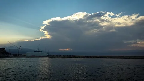 Huge storm cloud expanding at sunset over sea port with yachts and boats ret Stock Footage 341437144