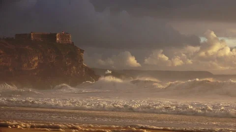 Huge stormy waves in front of lighthouse. Nazare, Portugal Video stock 128641122