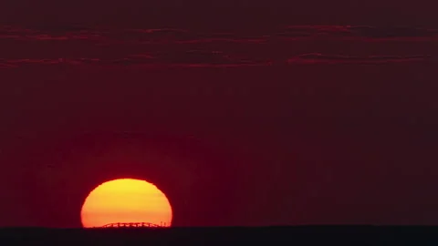 The huge sun at evening telephoto view time lapse Stock Footage 160261663