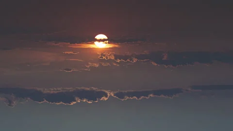 The huge sun moving behind the stormy clouds Stock Footage 167332340