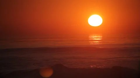 A Huge sun setting over big waves 2 Video stock 34464547