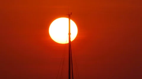 Huge sunset with moving ship masts and lightning rod of yacht boat without ca Stock Footage 128067199