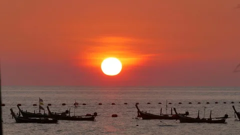 Huge sunset over ocean,moving thai national flag on long tail fishing boat mo Stock Footage 128344939