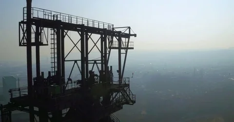 Huge tower and chimneys at an old steel factory against a foggy background Stock Footage 81534539