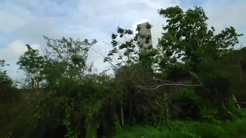 Huge tower looks like chimney attached to the factory of Finolex J Power Syst Stock-Footage 284959823
