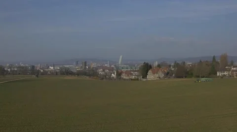 Huge tractor with trailer, spreading liquid manure. Panoramic view of City Basel Stock Footage 48014446