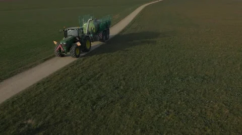 Huge tractor with trailer, spreading liquid manure. Panoramic view of City Basel Stock Footage 48015117