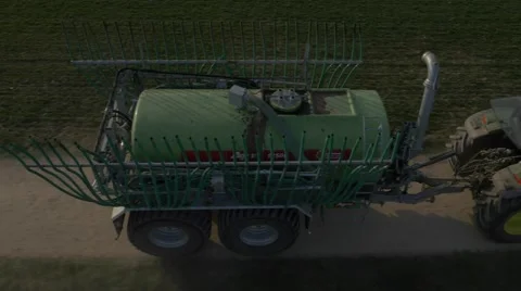 Huge tractor with trailer, spreading liquid manure. Stock Footage 48016017