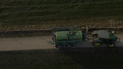 Huge tractor with trailer, spreading liquid manure. Stock Footage 48016108
