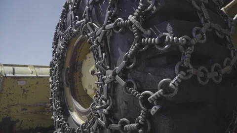 Huge tractor wheel equipped with traction chain Stock Footage 143967103