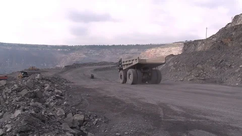 Huge trucks drive through an iron ore quarry Stock Footage 101906810