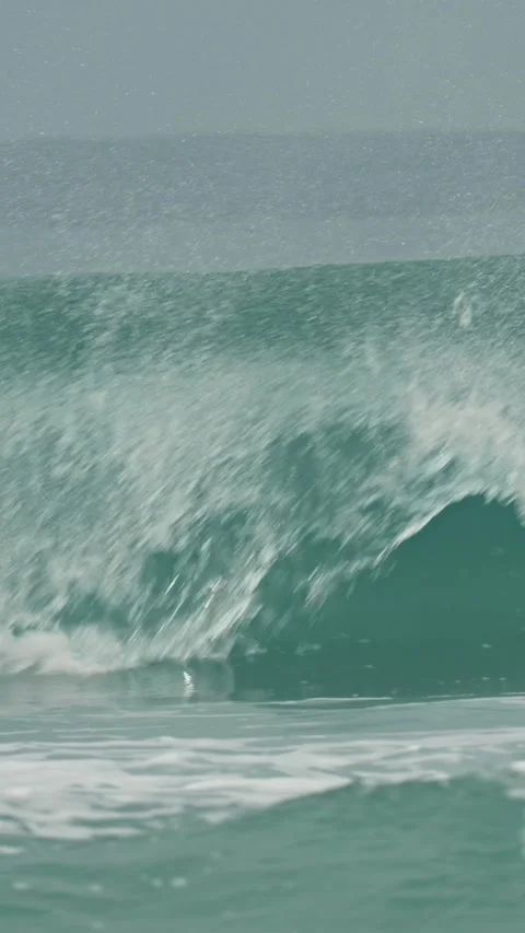 Huge turquoise wave creating a barrel and then crashing with immense force Stock-Footage 346008511