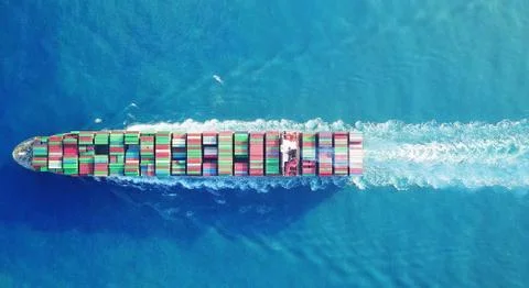 Huge ULCV container ship top down view sails on open water fully loaded Stock Photos