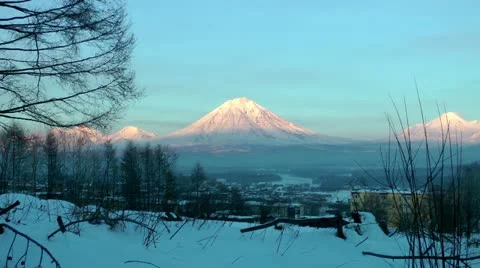 The huge volcano in the twilight of winter day, the sun shines its ice slopes Stock Footage 11899313
