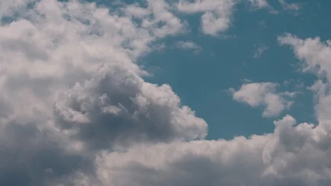 Huge volumetric clouds fly in the sky Stock Footage 128966071