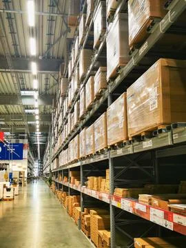 Huge warehouse-type store with large racks filled with packaged goods Stock Photos