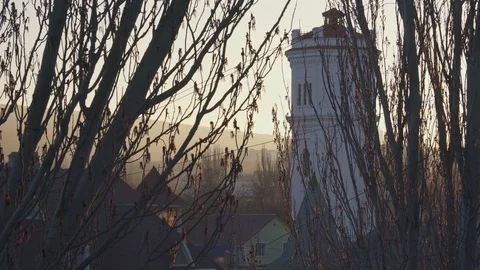 Huge water tower behind the trees at sunset Stock Footage 105278436