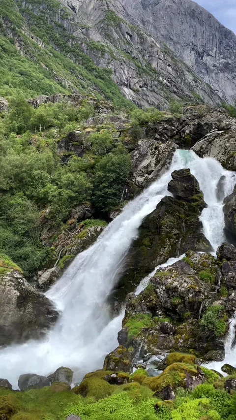 A huge waterfall flows down from the mountains Stock Footage 337364950