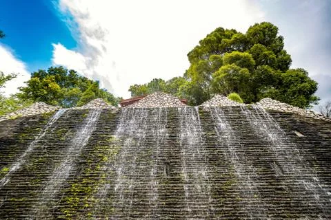 Huge waterfall surrounded by trees Stock Photos