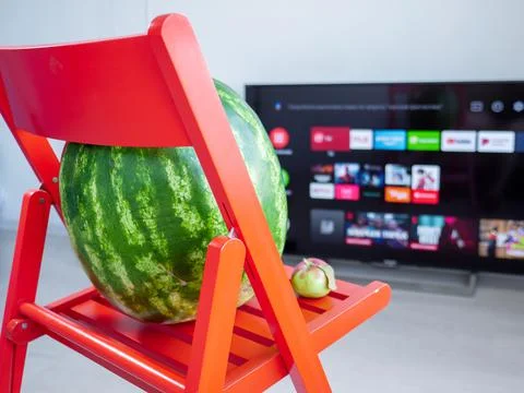 Huge watermelon and tiny apple. Opposites attract concept. Stock Photos