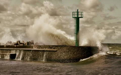 Huge wave crashed against the breakwater near the seaport Stock Photos
