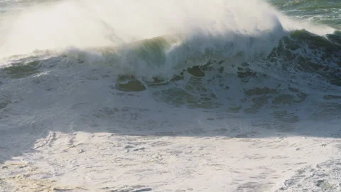 A huge wave crashing with splashes off the coast of Nazare, Portugal Stock Footage 305639644